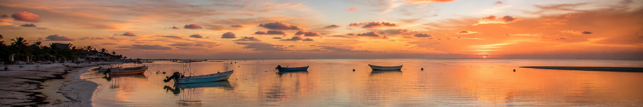 Car-free sandy street and shallow lagoon beach on Holbox Island north of the Yucatan Peninsula