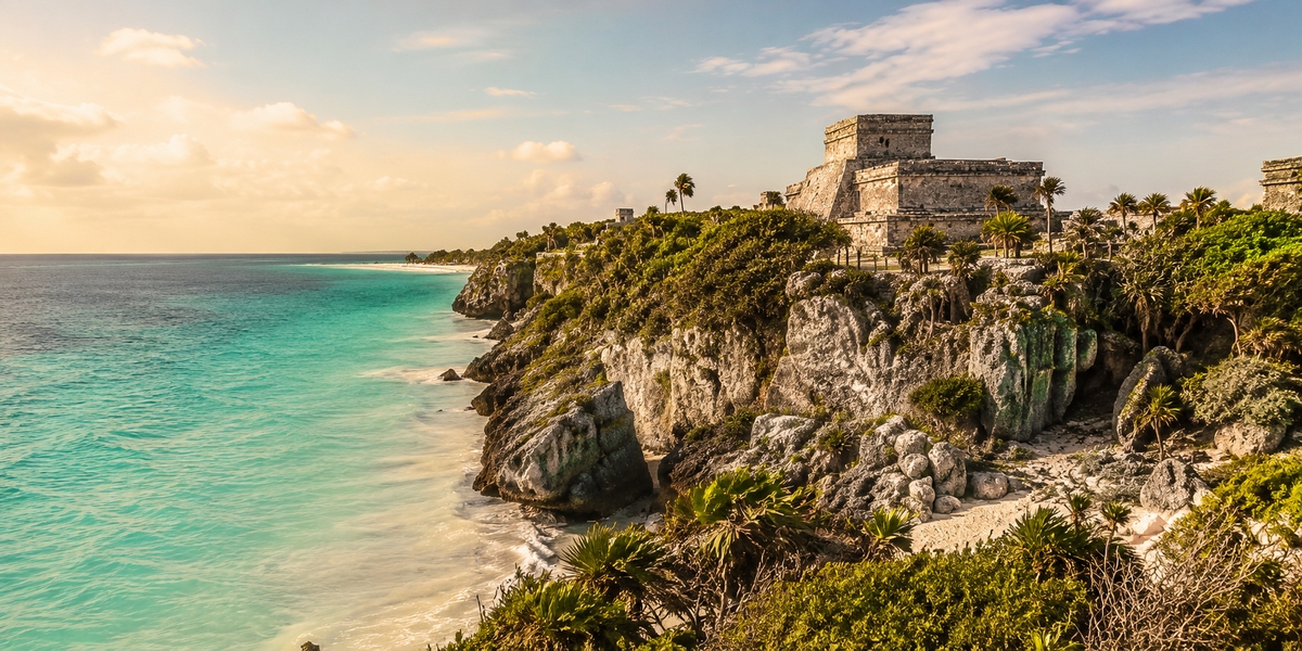 El Castillo temple on the cliff edge at Tulum with the Caribbean behind it